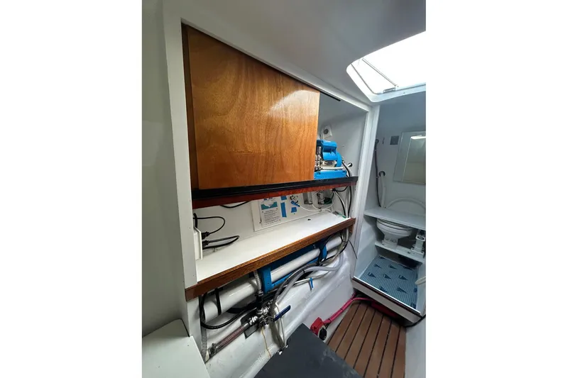 Slide: The Image of Interior of 2002 Custom 64 Stuart Catamarans showing bathroom and storage area. - 43