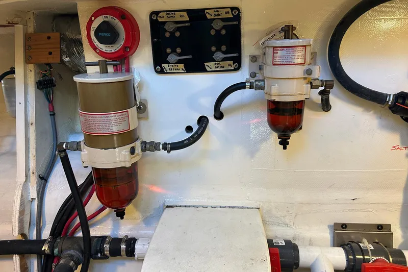 Slide: The Image of Engine room of 2002 Custom 64 Stuart Catamarans with fuel filters and wiring. - 49