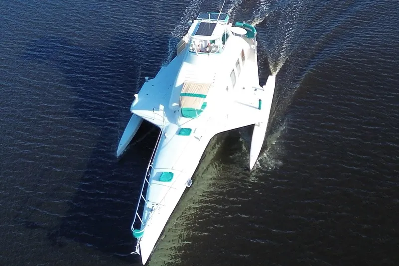 Slide: The Image of Aerial view of a 2002 Custom 64 Stuart Catamarans sailing on water. - 5