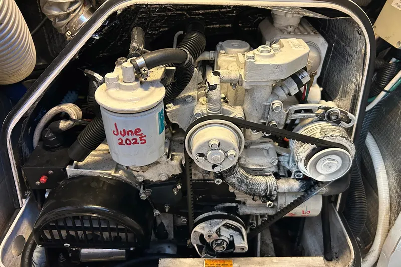 Slide: The Image of Engine compartment of 2002 Custom 64 Stuart Catamarans with visible filter marked "June 2025". - 53