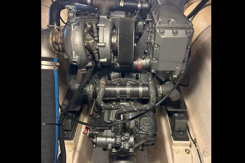 Slide: The Image of Engine of a 2002 Custom 64 Stuart Catamarans, showcasing intricate mechanical components. - 56