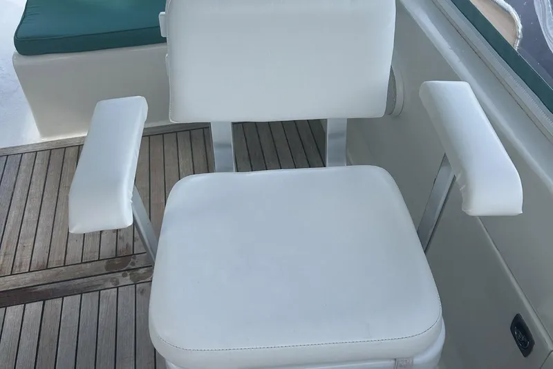 Slide: The Image of White cushioned chair on a 2002 Custom 64 Stuart Catamarans yacht deck. - 8