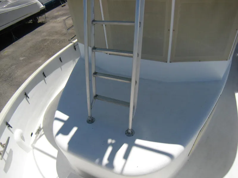 Slide: The Image of 1987 Custom Pilgrim Tribute boat deck with ladder, showcasing sleek white design. - 32