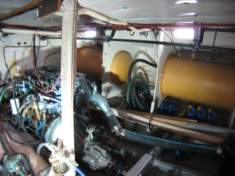 Slide: The Image of Engine room of 1987 Custom Pilgrim Tribute boat with visible machinery and wiring. - 47