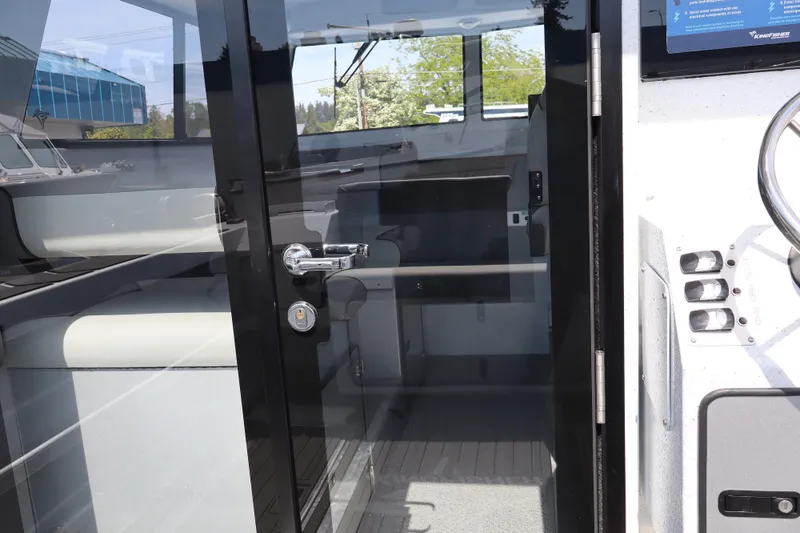 Slide: The Image of Interior view of 2026 KingFisher 25 XAC boat through glass door. - 16
