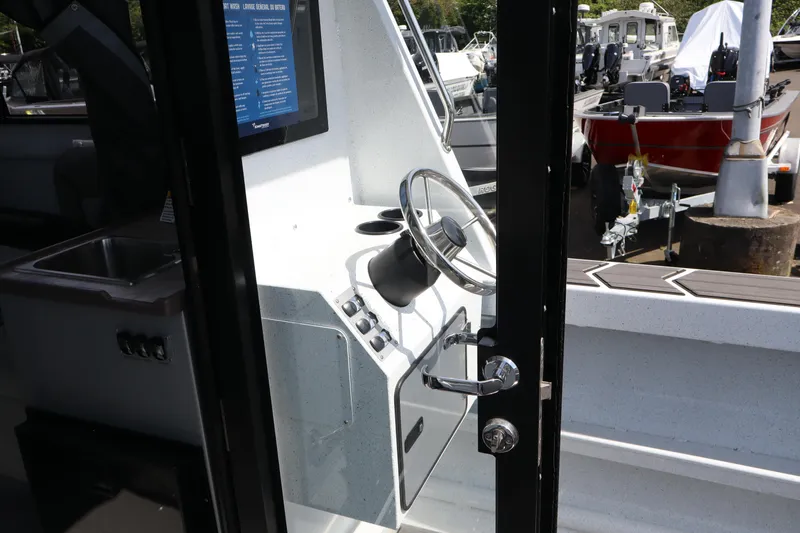 Slide: The Image of Interior view of 2026 KingFisher 25 XAC boat, showcasing steering wheel and control panel. - 17