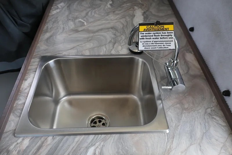 Slide: The Image of Stainless steel sink with caution sign in 2026 KingFisher 25 XAC boat kitchen. - 19