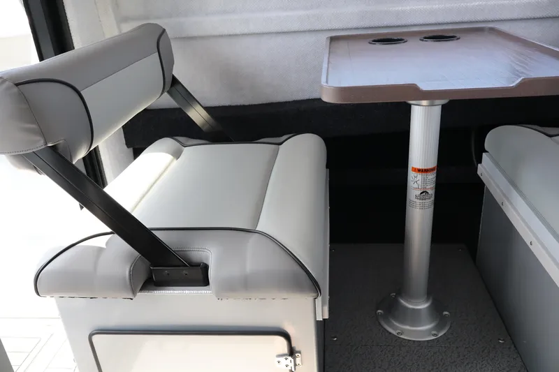 Slide: The Image of Interior seating and table of 2026 KingFisher 25 XAC boat, featuring modern design. - 22