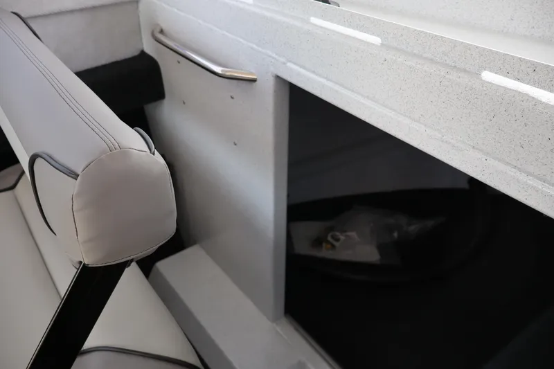 Slide: The Image of Interior of 2026 KingFisher 25 XAC boat, featuring seating and storage compartment. - 25