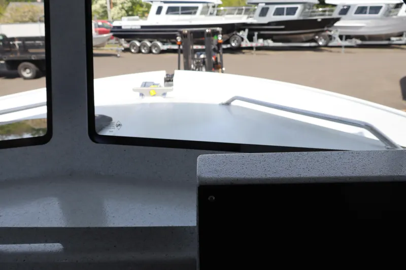Slide: The Image of Interior view from KingFisher 25 XAC boat, showcasing the deck and parked boats outside. - 26