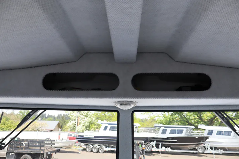 Slide: The Image of Interior view of 2026 KingFisher 25 XAC boat with overhead storage compartments. - 29