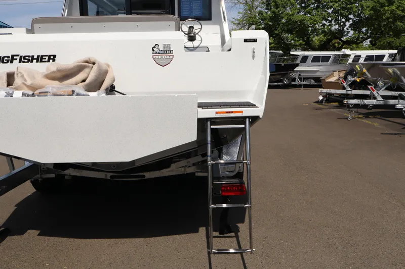 Slide: The Image of Rear view of a 2026 KingFisher 25 XAC boat with ladder and trailer. - 31
