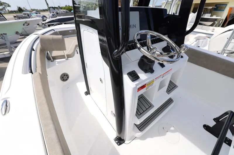 Slide: The Image of Interior view of 2026 Sea Hunt Ultra 239 SE boat, featuring seating and speaker. - 14
