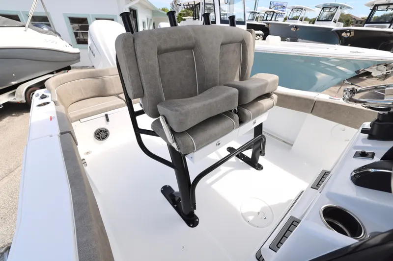 Slide: The Image of 2026 Sea Hunt Ultra 239 SE boat interior with dual cushioned seats and steering wheel. - 15