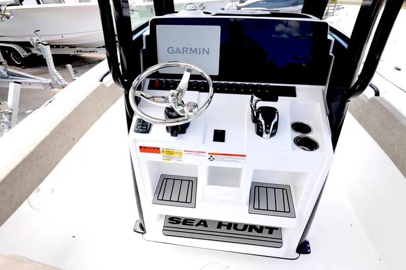 Slide: The Image of 2026 Sea Hunt Ultra 239 SE boat with powerful outboard motor, displayed outdoors. - 3