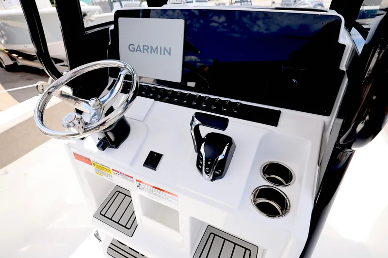 Slide: The Image of 2026 Sea Hunt Ultra 239 SE boat interior with cushioned seating and steering wheel. - 7