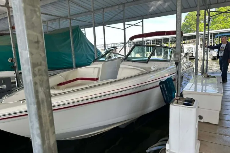 The Image of 2002 Formula 280 Bowrider docked under covered marina with a person nearby. - 1