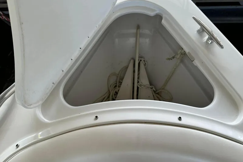 Slide: The Image of Open storage compartment on a 2002 Formula 280 Bowrider boat, containing ropes and anchor. - 11