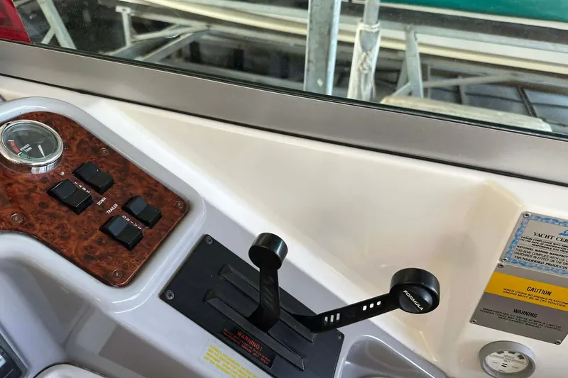Slide: The Image of Control panel of a 2002 Formula 280 Bowrider boat with switches and throttle. - 12