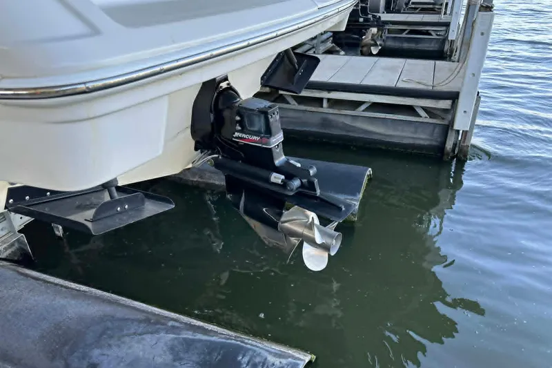 Slide: The Image of Rear view of a 2002 Formula 280 Bowrider boat with Mercury outboard motor. - 14