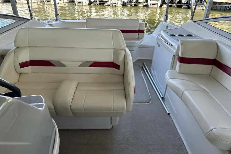 Slide: The Image of Interior of a 2002 Formula 280 Bowrider boat with cream and red seating. - 15