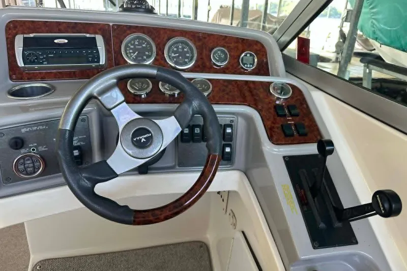 Slide: The Image of Steering console of a 2002 Formula 280 Bowrider boat with wood accents and controls. - 17