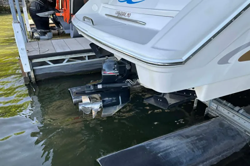 Slide: The Image of Rear view of a 2002 Formula 280 Bowrider boat docked, showing Mercury outdrive. - 18