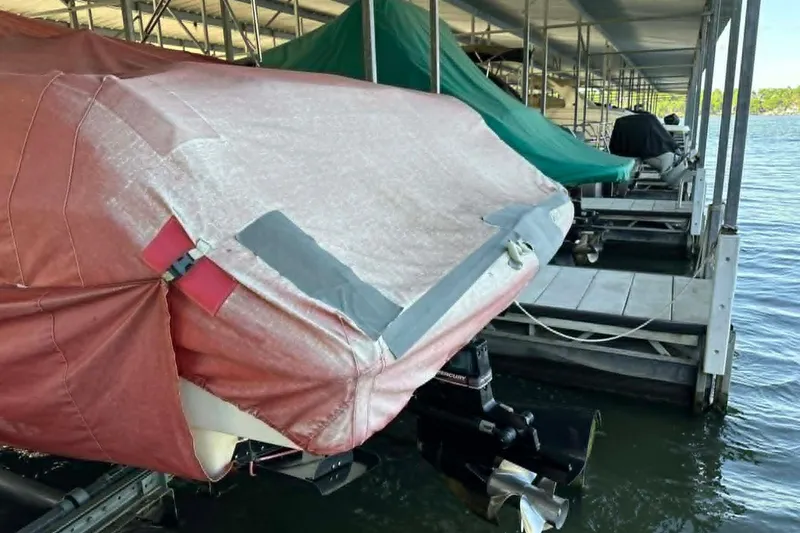Slide: The Image of Covered 2002 Formula 280 Bowrider docked, with protective tarp and visible outboard motor. - 19