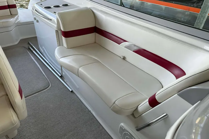 Slide: The Image of 2002 Formula 280 Bowrider interior with white and red seating, cup holders, and carpeted flooring. - 21