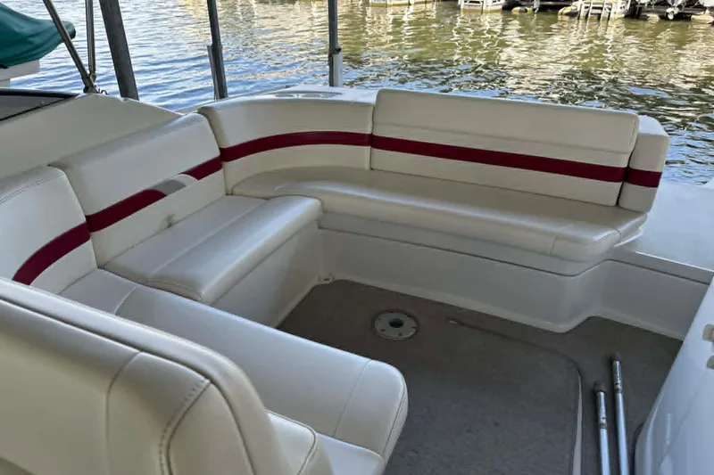 Slide: The Image of 2002 Formula 280 Bowrider boat interior with white and red seating by the water. - 23