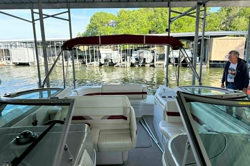 Slide: The Image of 2002 Formula 280 Bowrider boat docked, featuring spacious seating and canopy. - 24
