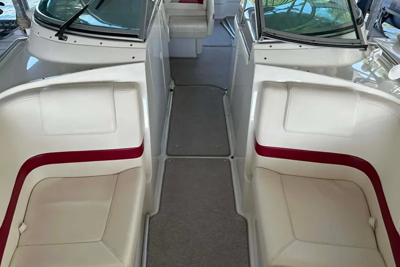 Slide: The Image of Interior view of a 2002 Formula 280 Bowrider boat with white and red seating. - 3