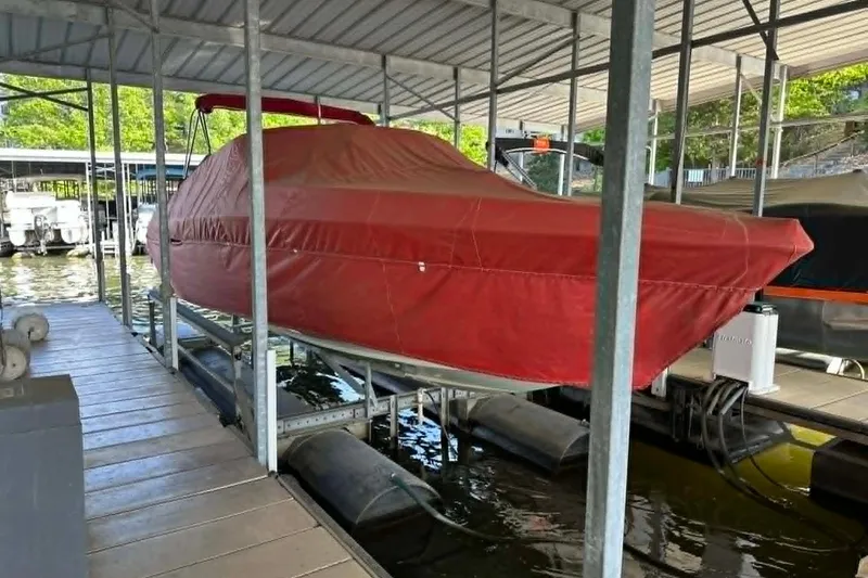 Slide: The Image of Covered 2002 Formula 280 Bowrider boat docked under a metal canopy. - 31