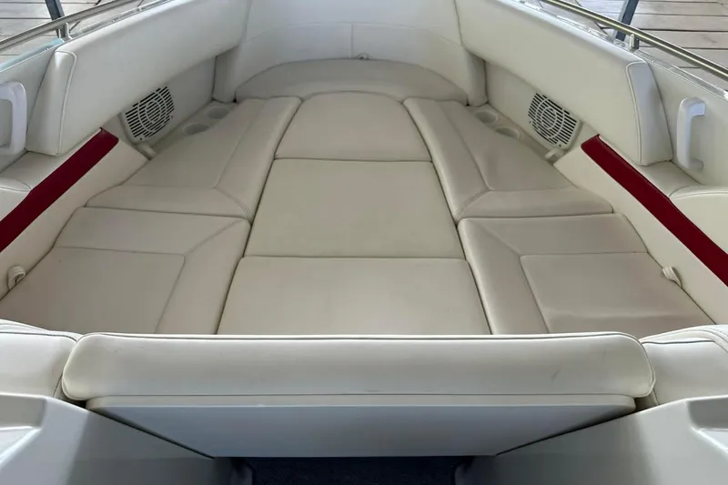 Slide: The Image of 2002 Formula 280 Bowrider interior with spacious white leather seating and built-in speakers. - 34