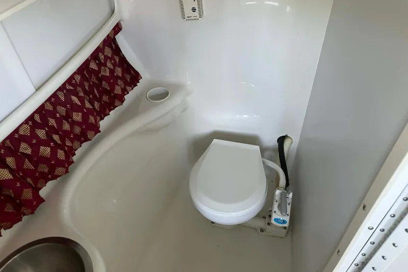 Slide: The Image of Interior of 2002 Formula 280 Bowrider boat bathroom with toilet and curtain. - 4