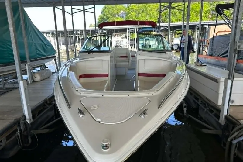 Slide: The Image of 2002 Formula 280 Bowrider docked in a marina, featuring spacious seating and sleek design. - 5