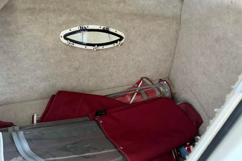 Slide: The Image of Storage compartment in a 2002 Formula 280 Bowrider with red canvas and clear panels. - 6