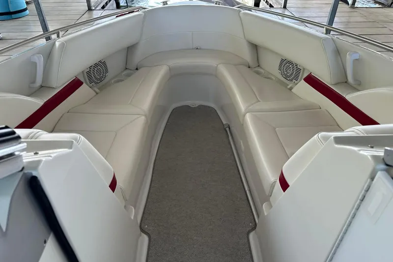 Slide: The Image of Interior of a 2002 Formula 280 Bowrider boat with white seating and red accents. - 8