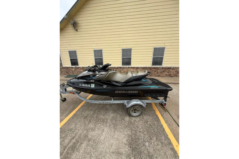 Slide: The Image of 2017 Sea-Doo GTX Limited 300 jet ski on trailer, parked outside a building. - 3