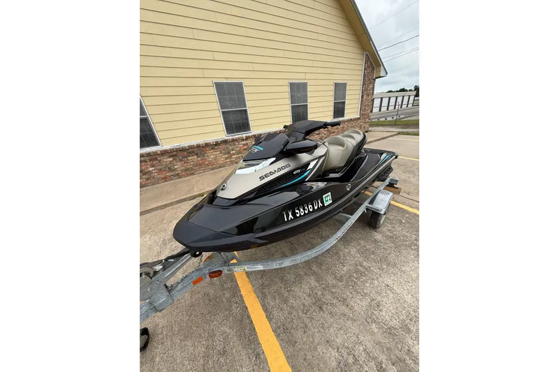 Slide: The Image of 2017 Sea-Doo GTX Limited 300 jet ski on trailer, parked outside a building. - 4