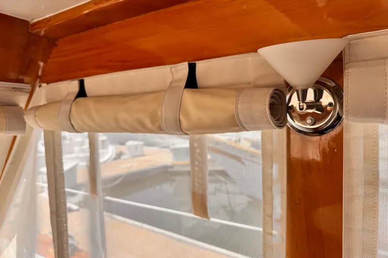Slide: The Image of 1978 Roughwater 41 interior with rolled curtains and wooden trim. - 10