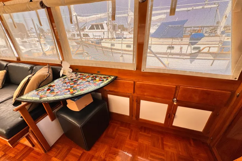 Slide: The Image of Interior of 1978 Roughwater 41 boat with mosaic table and leather seating. - 12