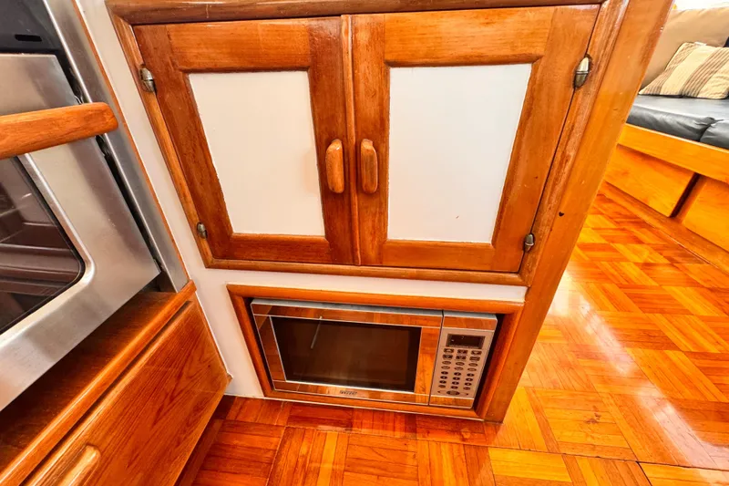 Slide: The Image of Wooden cabinetry with microwave in 1978 Roughwater 41 boat interior. - 17