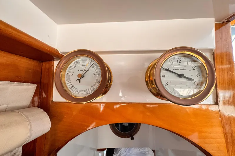 Slide: The Image of Vintage Roughwater 41 yacht interior with barometer and clock, showcasing classic wooden design. - 18