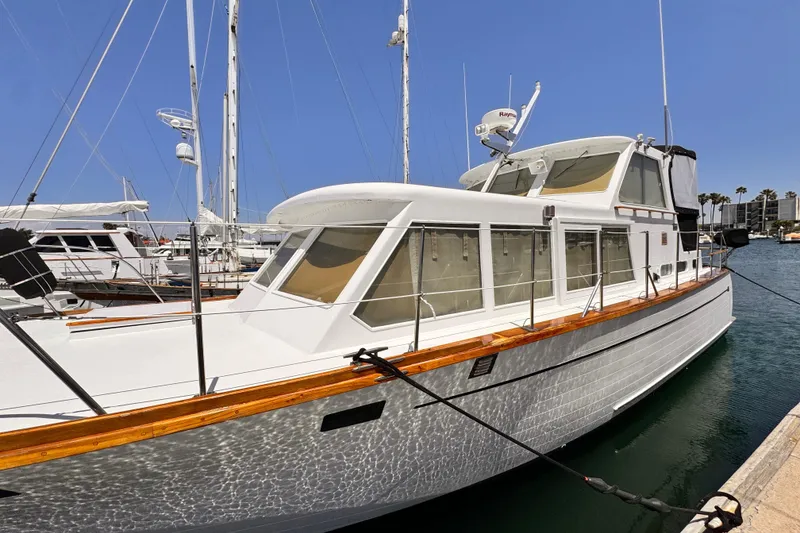 Slide: The Image of 1978 Roughwater 41 yacht docked at marina under clear blue sky. - 2