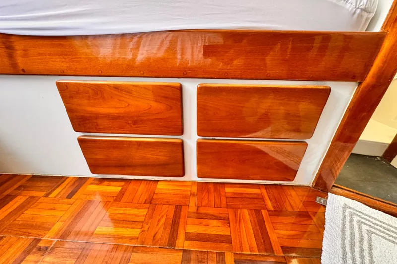Slide: The Image of Polished wooden interior of a 1978 Roughwater 41 boat, featuring parquet flooring. - 23
