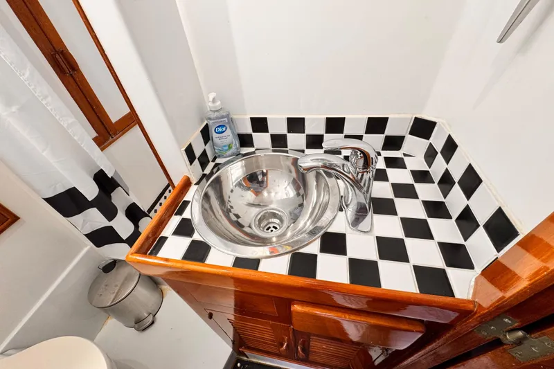 Slide: The Image of 1978 Roughwater 41 bathroom sink with checkered tiles and chrome faucet. - 27