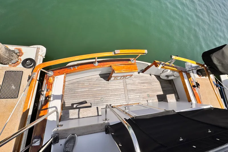 Slide: The Image of Stern view of 1978 Roughwater 41 boat with wooden deck and railing. - 36