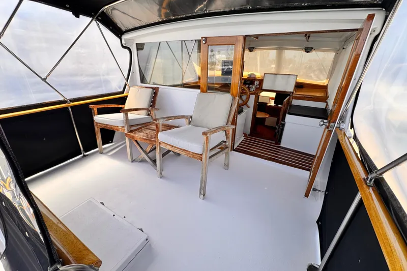Slide: The Image of 1978 Roughwater 41 boat interior with wooden chairs and helm station. - 37