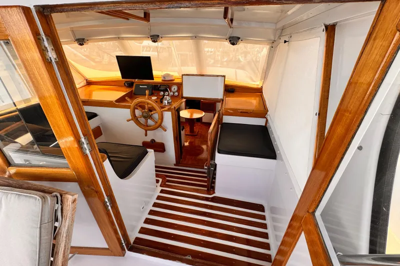 Slide: The Image of Interior of a 1978 Roughwater 41 boat with wooden accents and steering wheel. - 38